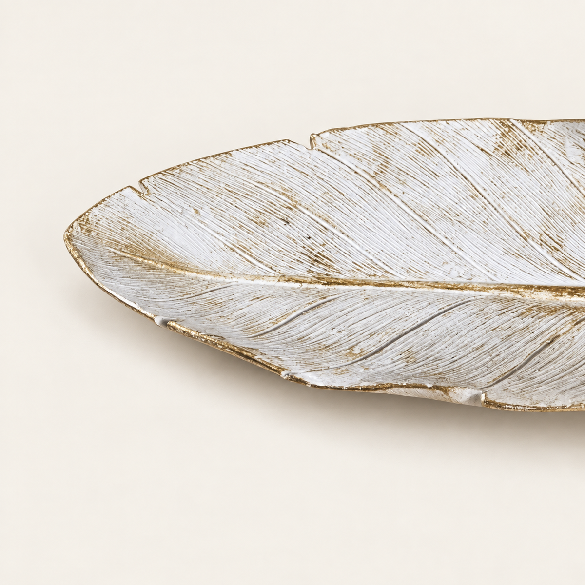 White tray close detail of leaf veins and gold-toned rim