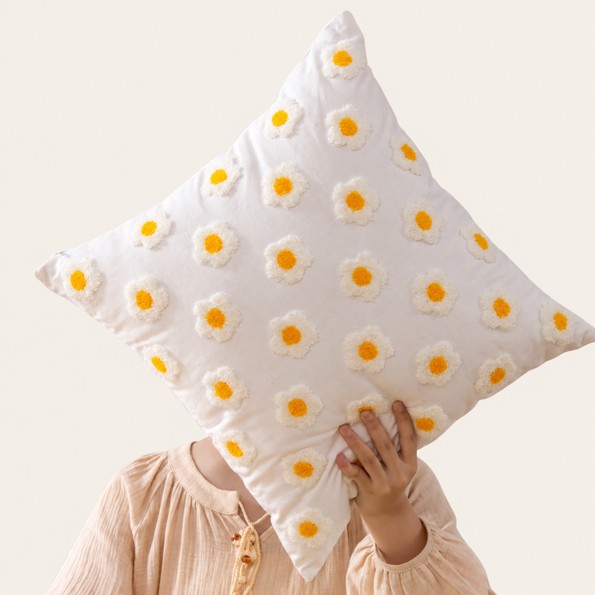 Embroidered Floral Cushion Cover - Small White Flowers, photographed with source holding hands retained on warm cream