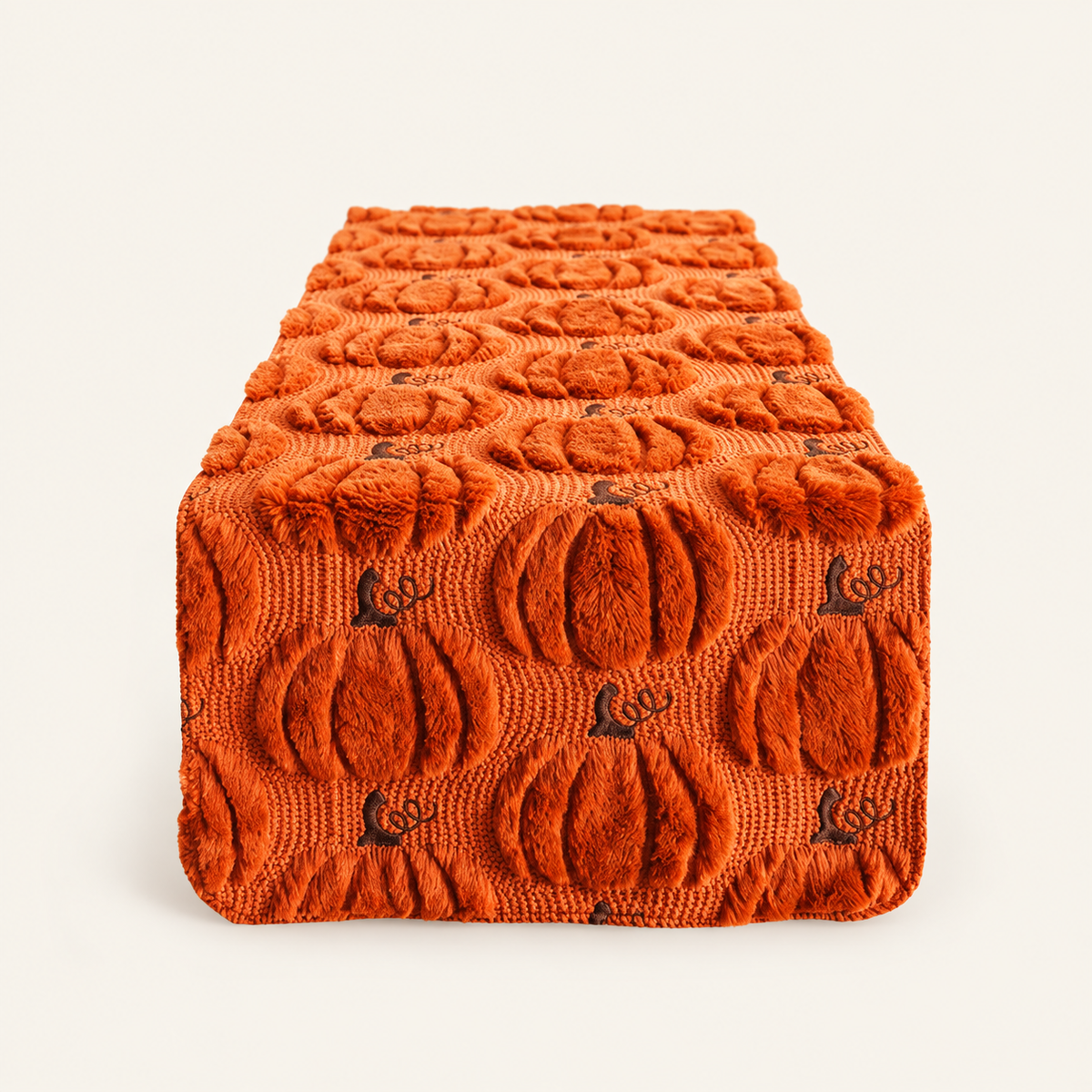 Caramel pumpkin-pattern runner with raised woven texture on a warm cream background