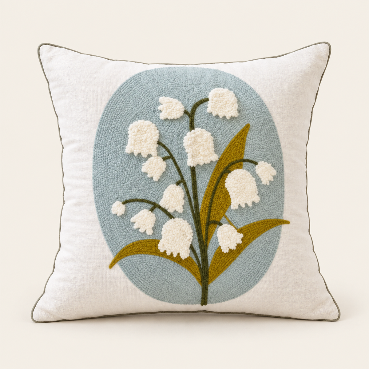 Embroidered Floral Cushion Cover — Blue lily of the valley flower on a cream studio background