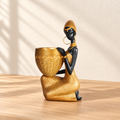 Basket Figure in black and gold on a warm ivory backdrop